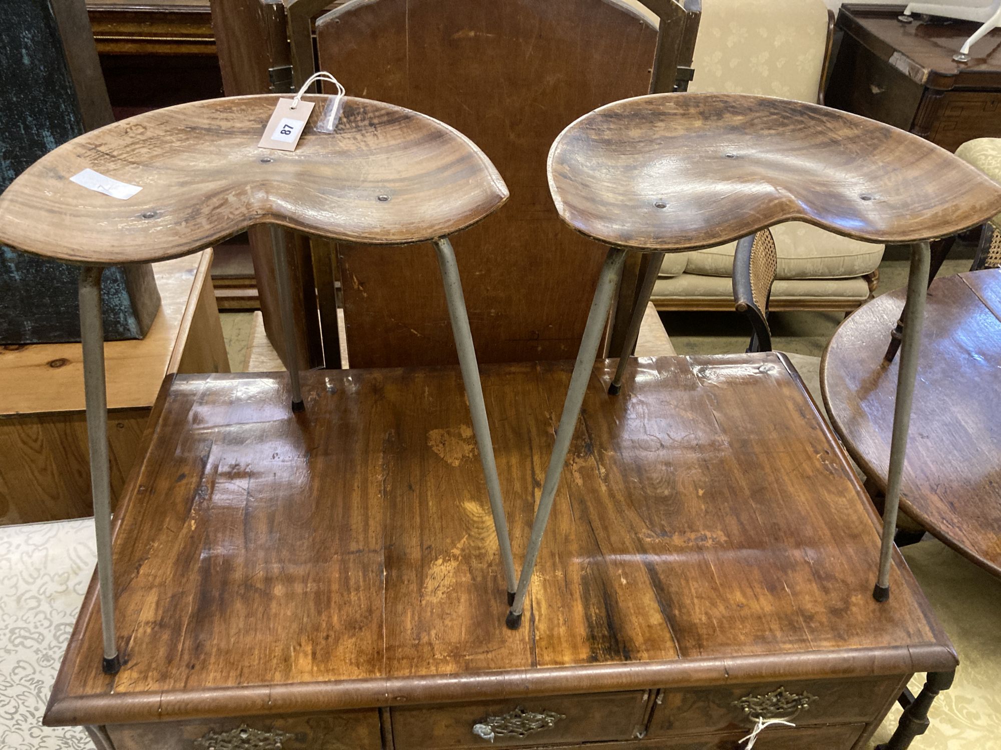 A pair of Arne Jacobsen-style saddle seat stools, width 39cm, depth 25cm, height 48cm
